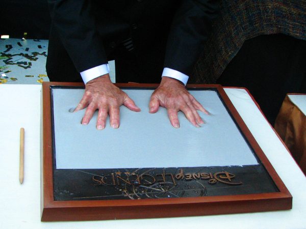 Ron pressing his hands into the cement